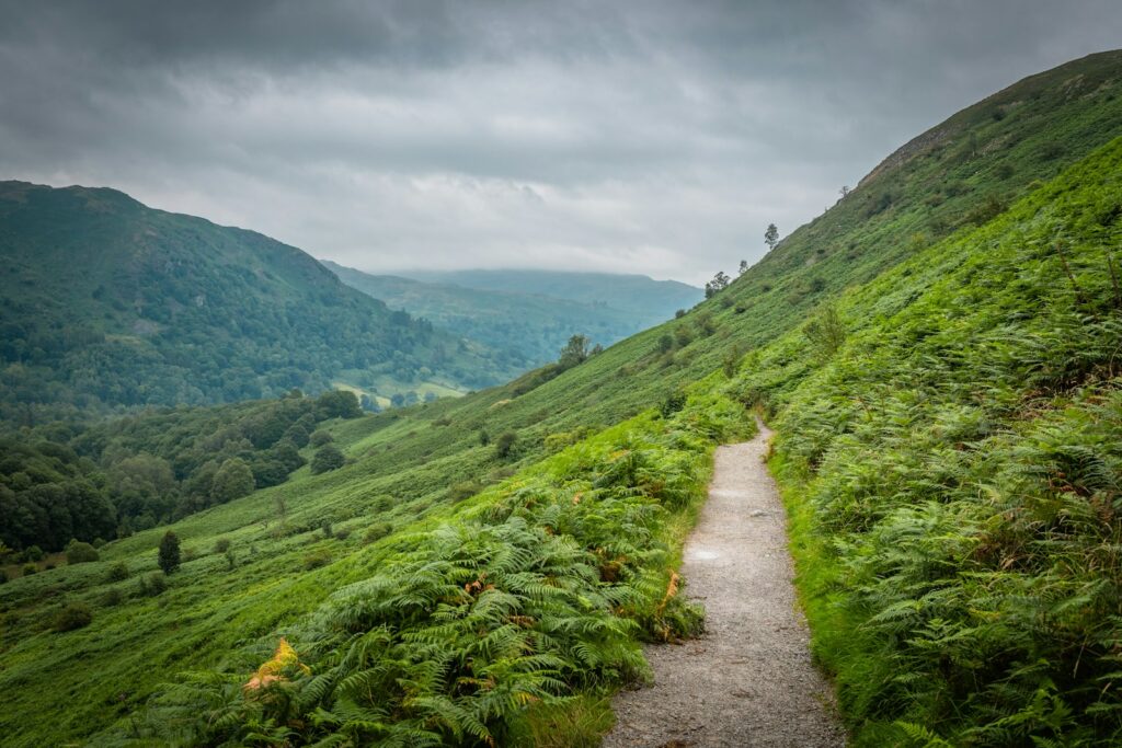 A green mountain trail through a Lake District valley on England's Coast to Coast Path