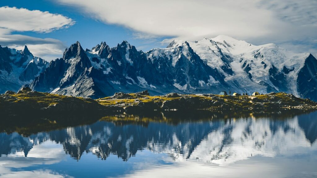 An alpine lake with the snowy Mont Blanc massif beyond