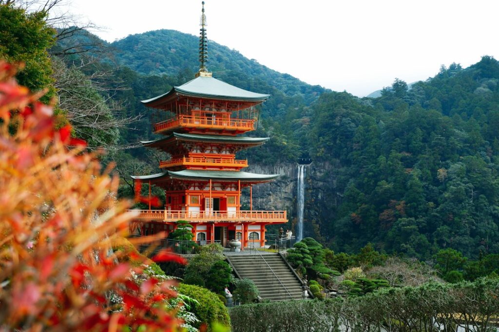 Red pagoda above wooded mountains at Nachi on the Kumano Kodo