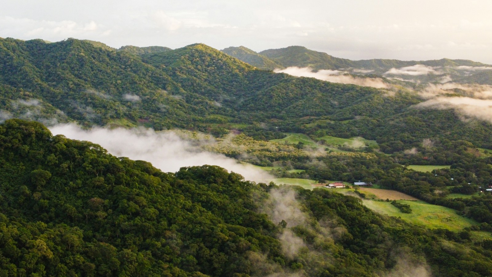 Green Costa Rican mountain ridges and mist, illustrative regional scenery