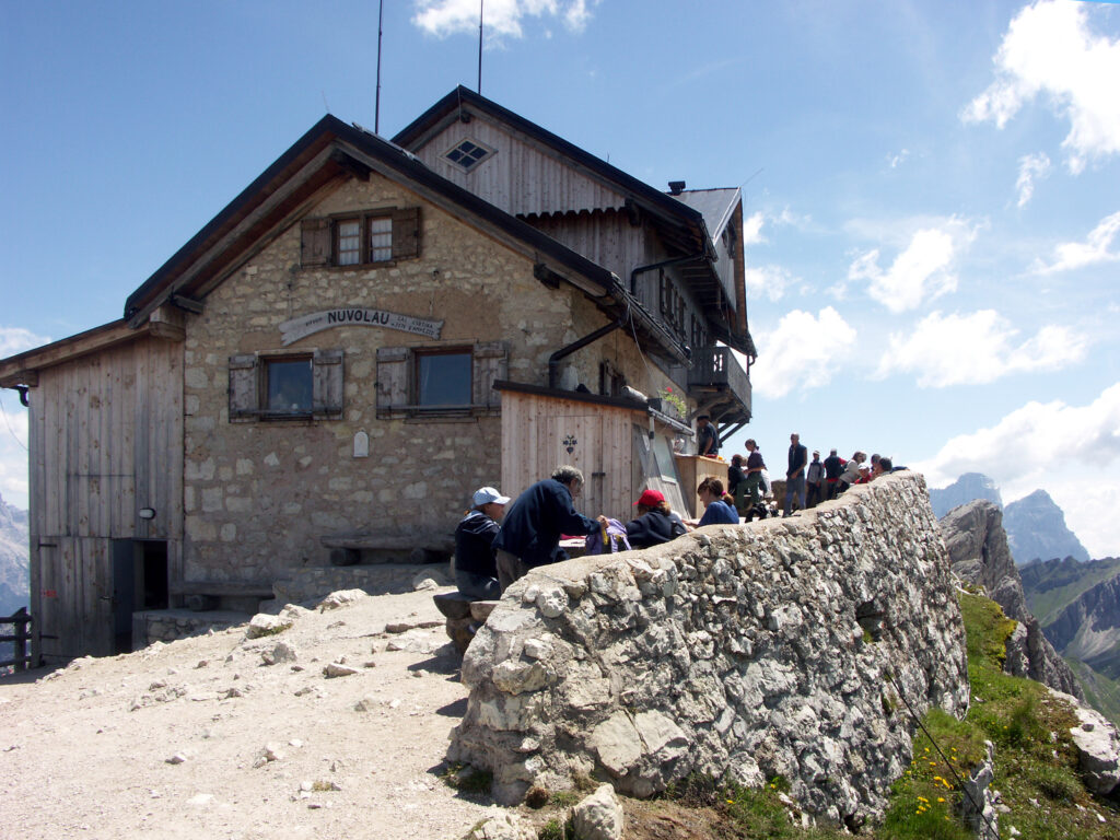 Stone and timber Rifugio Nuvolau with its terrace on a rocky summit